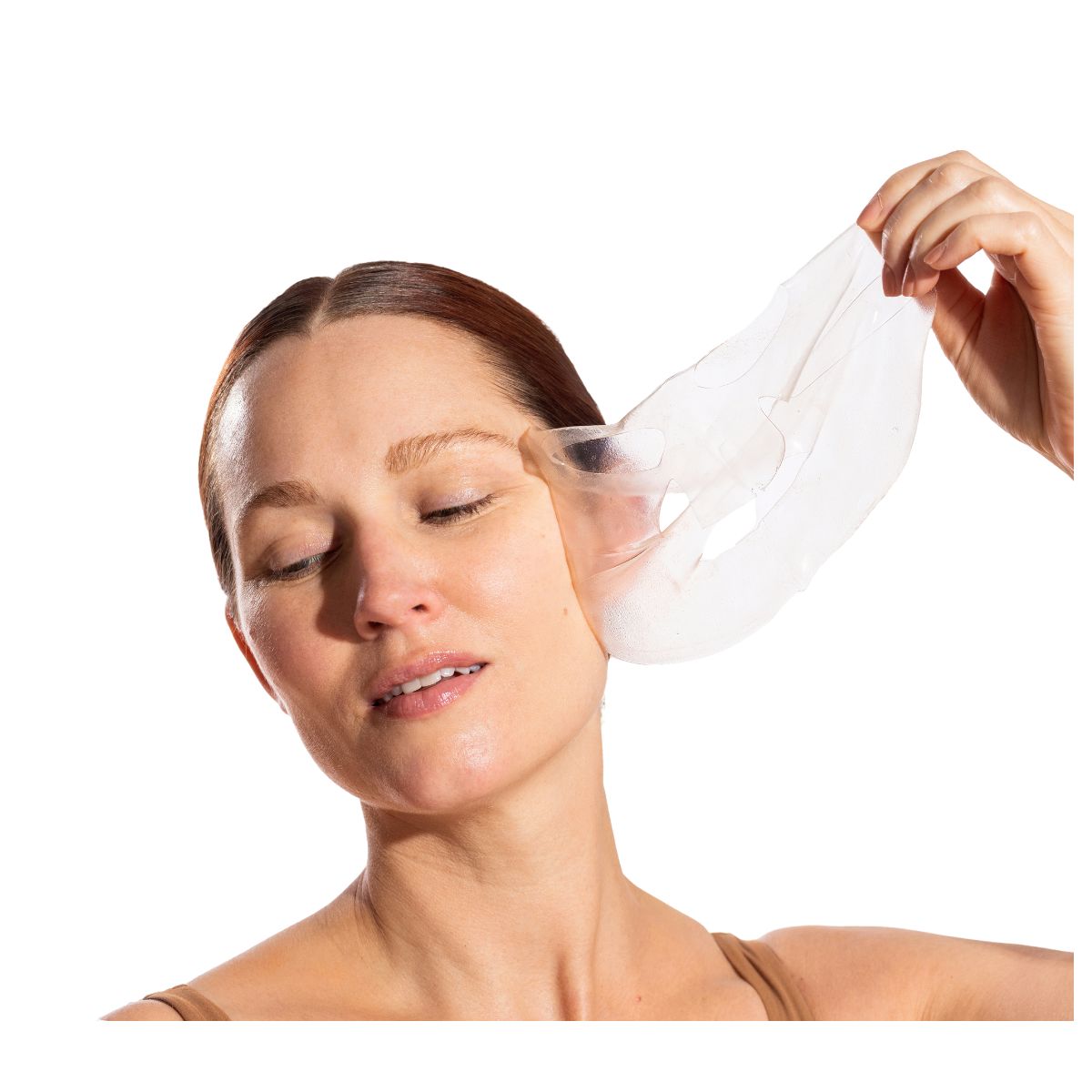 Woman removing the OmniLux HydroGel Facemask on a white background