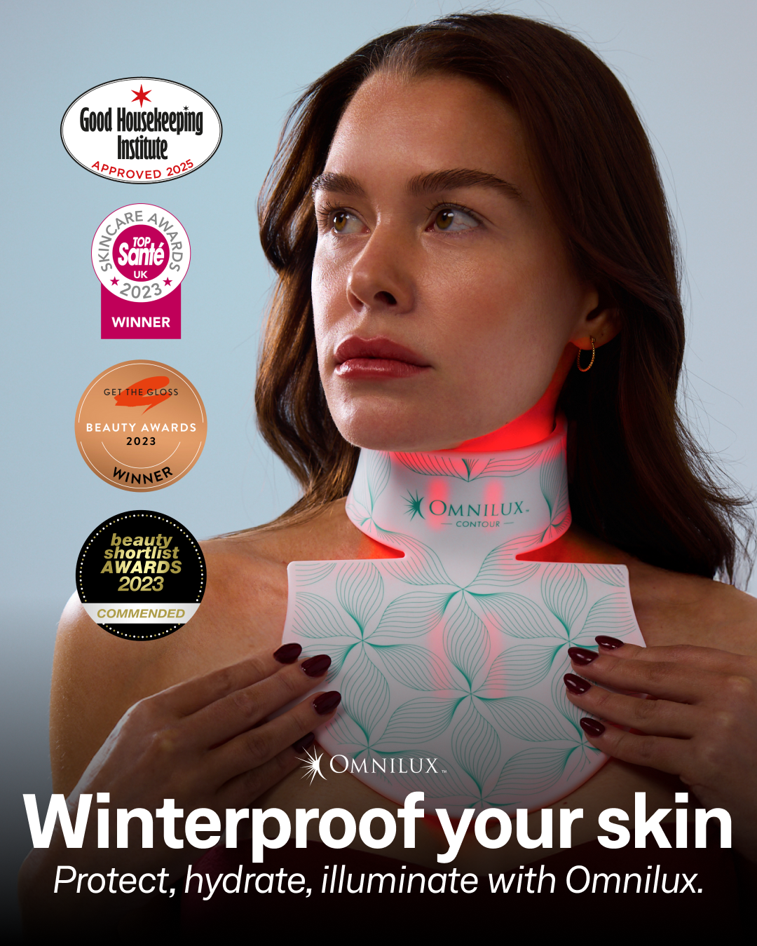 Woman using a skincare device with awards displayed, promoting Omnilux products.